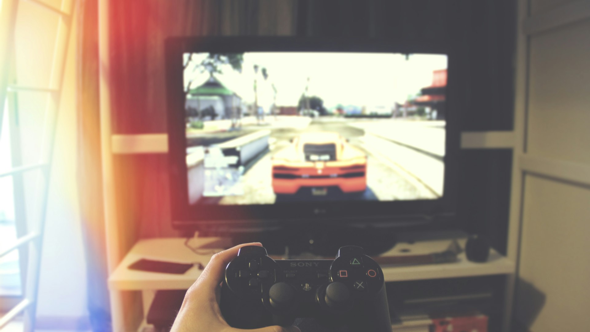 Handheld console glowing at a beachside desk